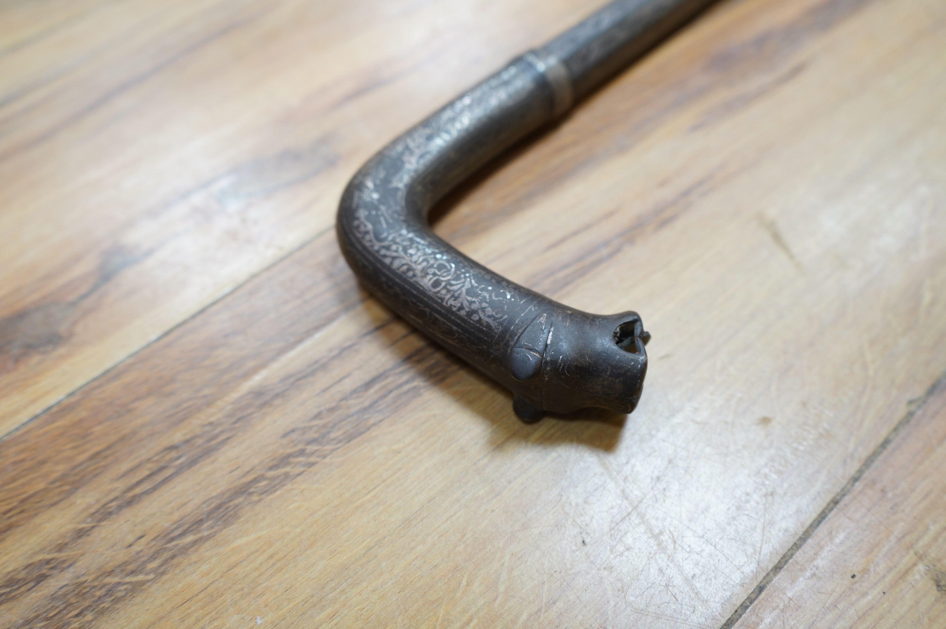 A 19th century Indian bidriware swordstick with stylised leopard handle, blade 14cm, overall length 97cm. Condition - fair to good, some surface wear.